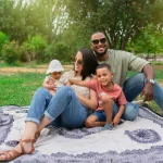 Happy family spanish-latin with their children in the park