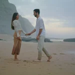 Romantic man proposing marriage to woman at beach. Couple celebrating engagement